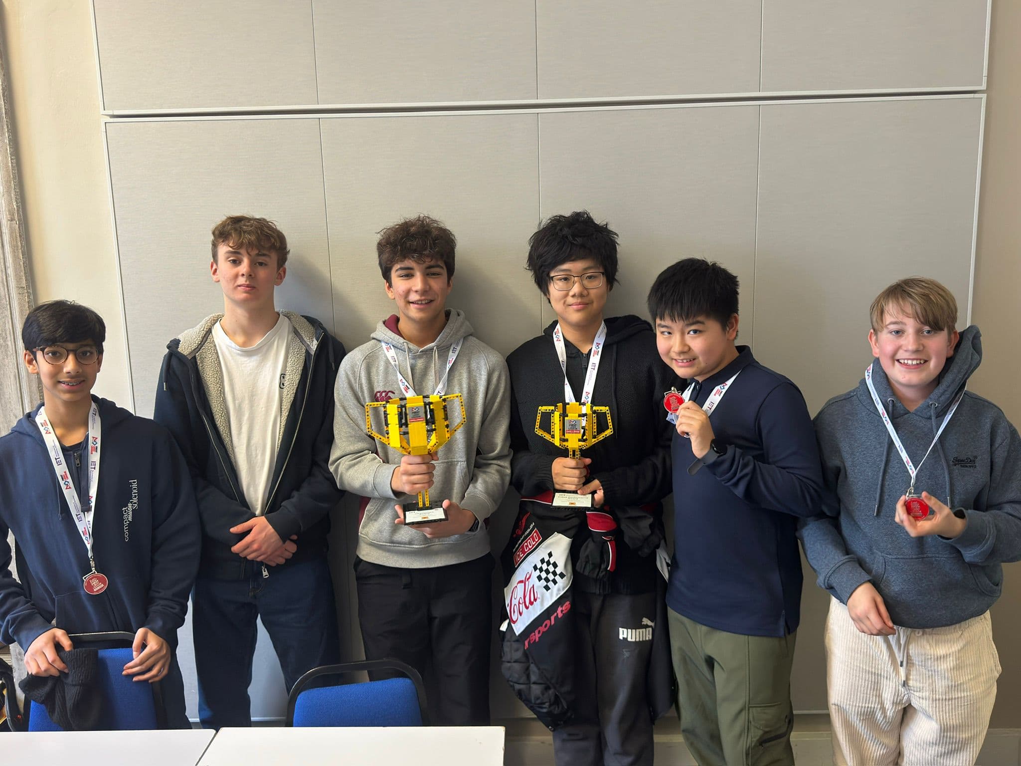 Team Euclid holding their FLL trophies and medals