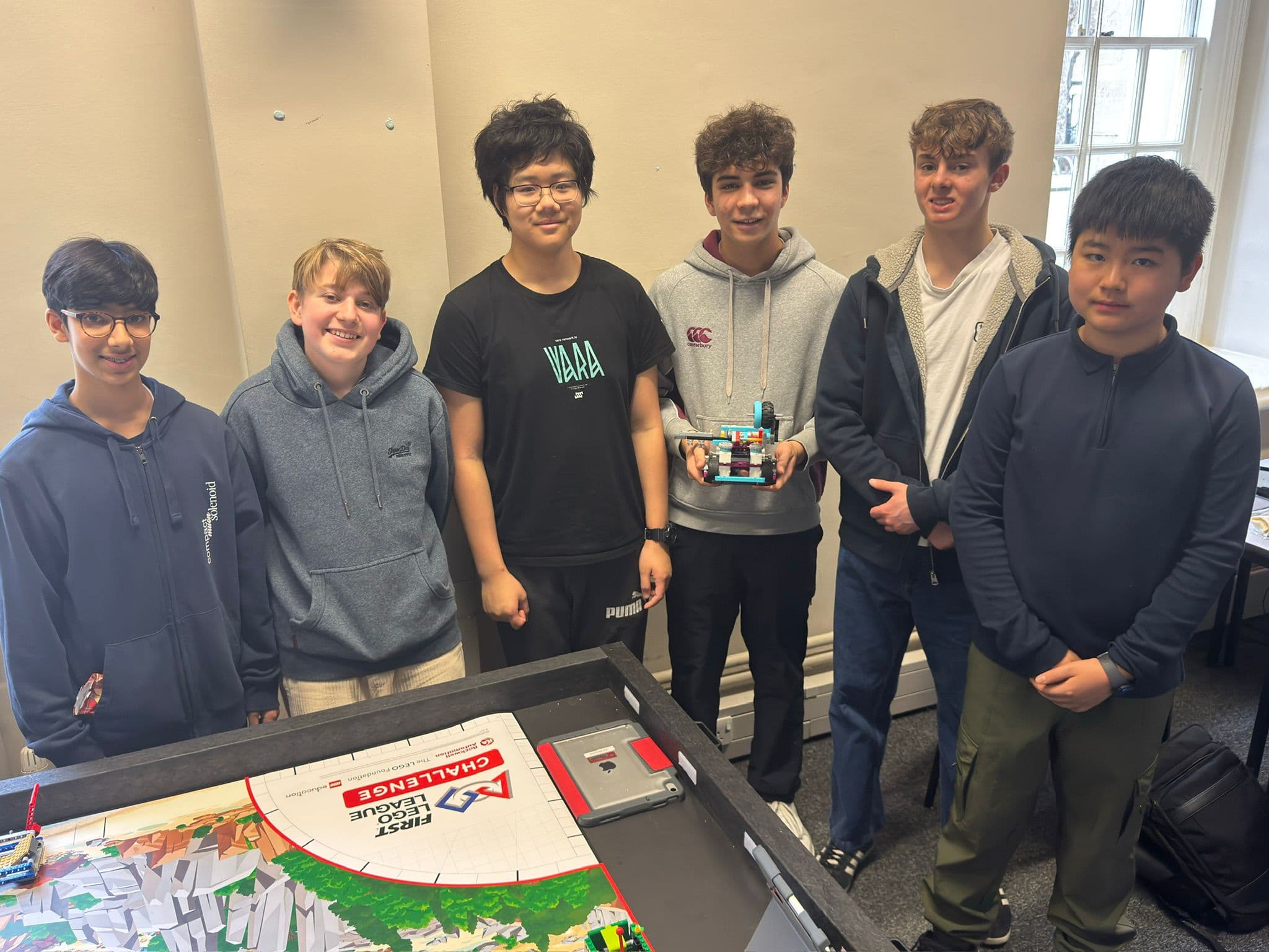 Team Euclid holding the robot in the workshop